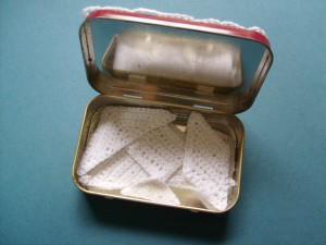 The crocheted tangrams fitting in the Altoids tin