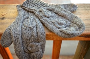 Mittens with knitted heart shaped leaves on a vine